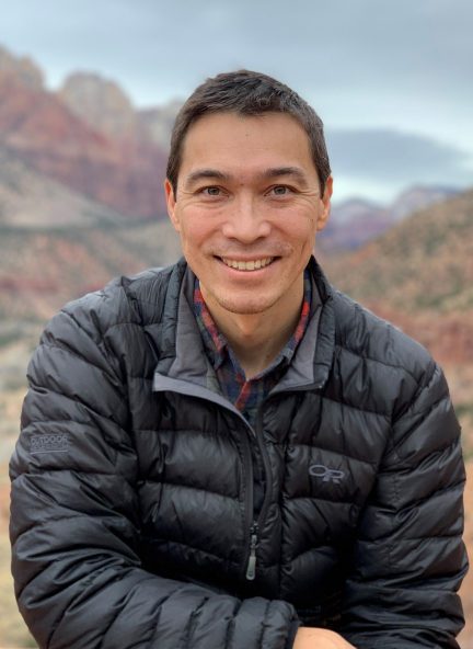 A man standing outside wearing a jacket